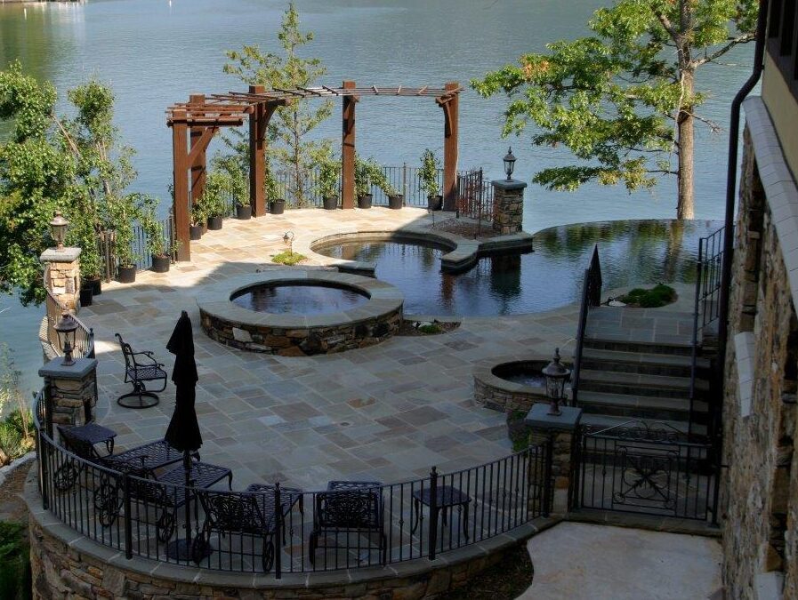 Residential outdoor space with a pool and lake in the background
